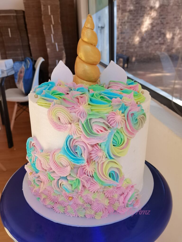 Pastel rainbow unicorn cake with gold horn