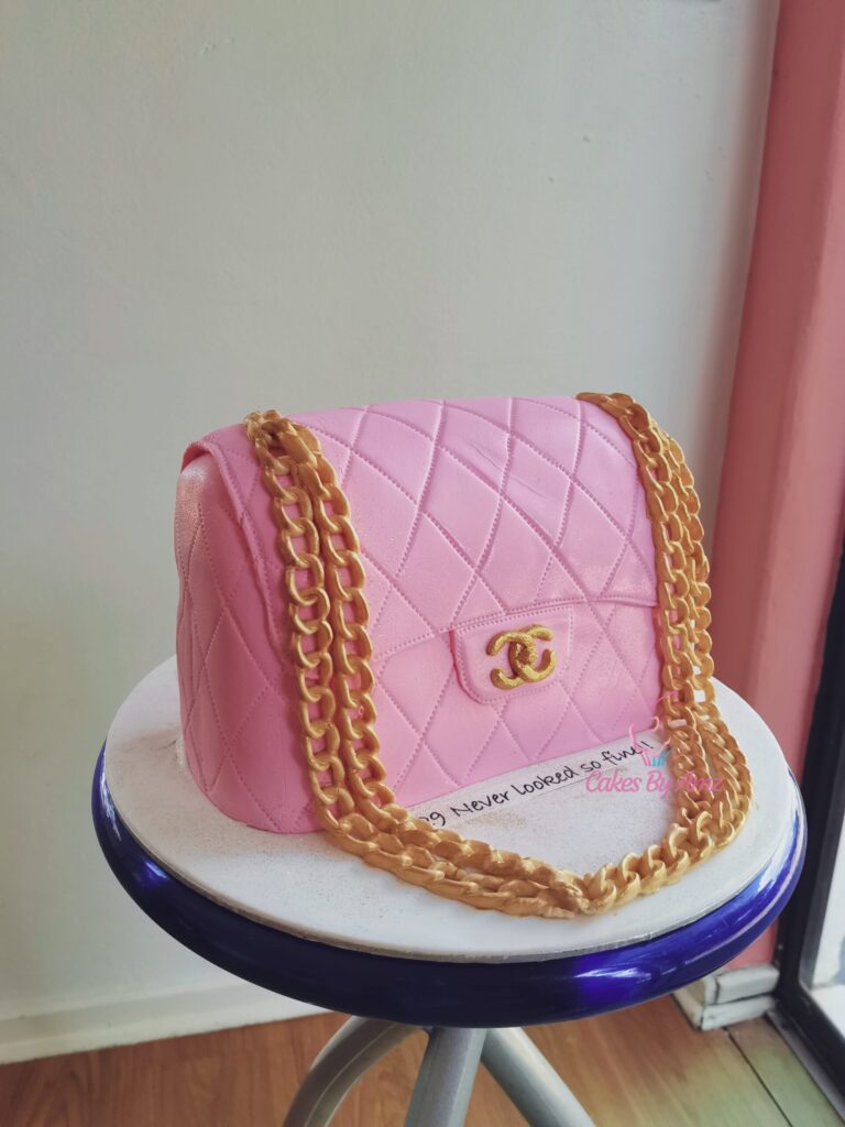 Pink quilted designer handbag cake with gold chain