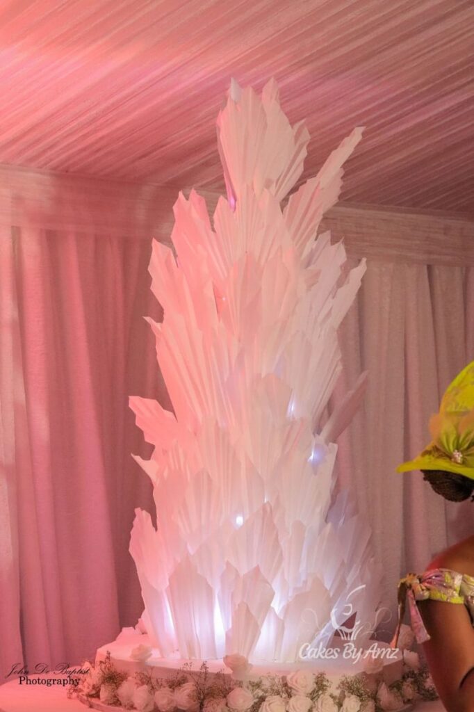 Illuminated white sculptural feather wedding cake