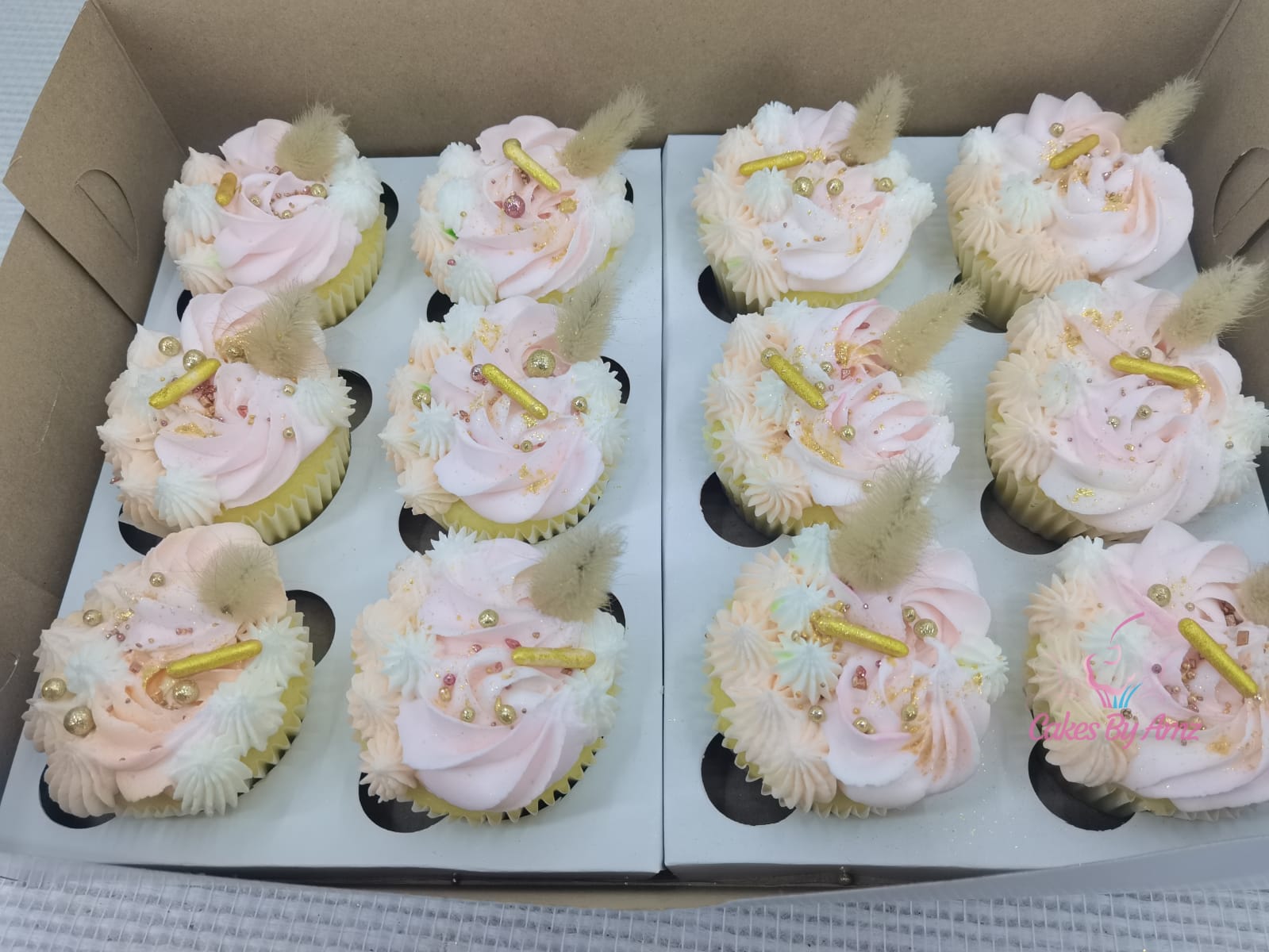 Boxed pink and gold celebration cupcakes